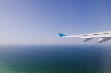 Airplane wing and blue sky