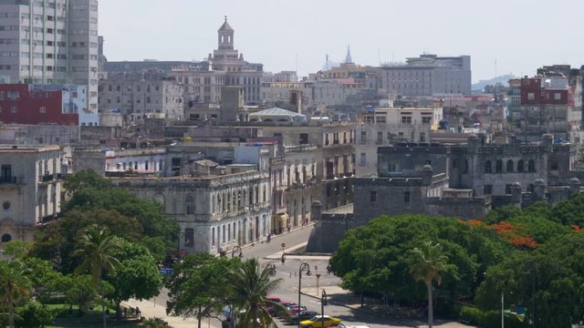 A slowly moving large format dolly establishing shot of old buildings in downtown Havana, Cuba. Shot in 5K.  	