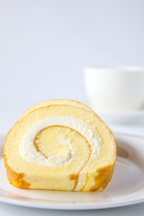 Swiss roll and coffee on white background.