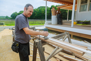 workers using electric routering to cut down stripes