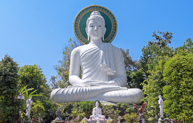 Great statue of Buddha on the background of blue sky. Peace, tranquility and silence concept.