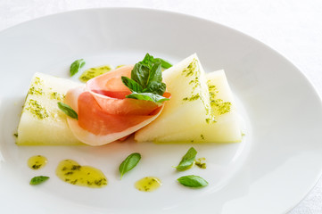 melon and prosciutto sprinkled with basil, lemon, and olive oil based sauce