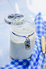 Wheat Flour with egg whisk on blue Checkered fabric