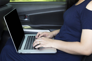 Businesswoman working in her car