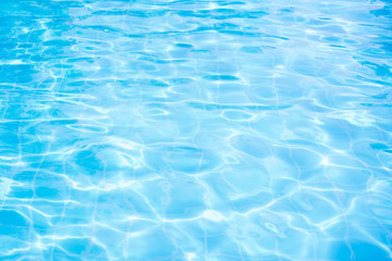 Fototapeta na wymiar Abstract water wave, sun reflections in pool water