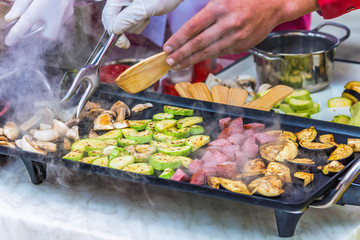 cooking sausages, vegetables, mushrooms on the grill