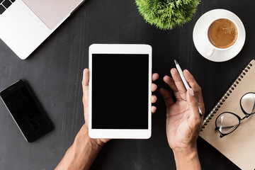 hand showing digital tablet blank screen on work desk