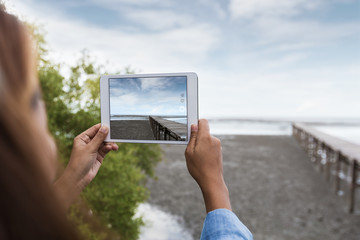 woman use digital tablet taking landscape photo - Powered by Adobe