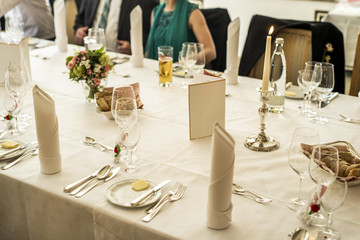 Table setup at marriage waiting for guests with dishes water flowers