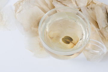 The Oroxylum indicum seed is used in the traditional Indian and Chinese medicine. And using it to make tea in a glass cup.
