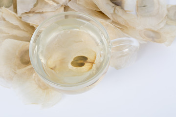 The Oroxylum indicum seed is used in the traditional Indian and Chinese medicine. And using it to make tea in a glass cup.