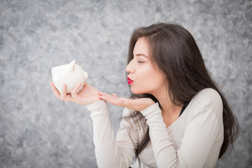Beautiful young girl saving money for holiday season, saving money concept