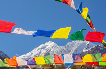 Colorful prayer flags, blowing in the wind in the Himalaya, on the Annapurna trekking circuit in autumn