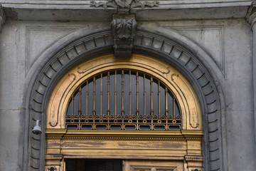 gilded transom window above exterior doors in old Montreal city