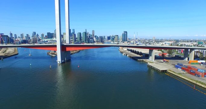 Aerial of Bolte Bridge, Melbourne City with traffic and freight movement.