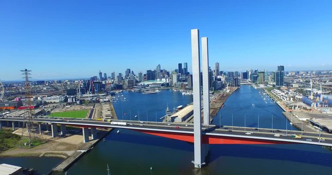 Aerial of Bolte Bridge, Melbourne City with traffic and freight movement.