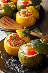 Round yellow and green zucchini baked with fillings close-up. vertical