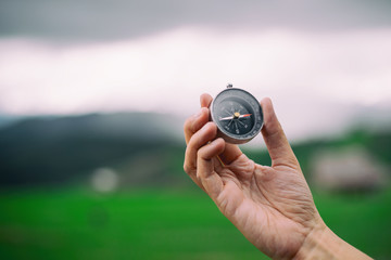 traveler woman search location with compass in mountains