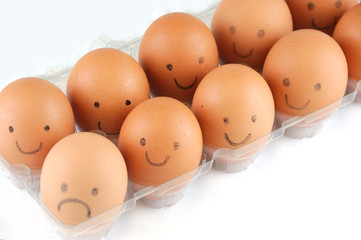 brown eggs with smile and sad face drawing