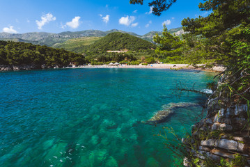Lucice beach near Petrovac, Montenegro. Lucice landscape- sandy beach on Montenegrin coast with clear water and pine trees around.