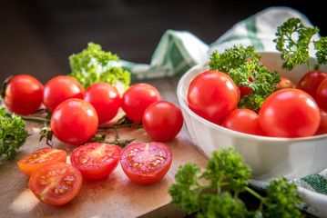 Cherry tomatoes in a plate on a wooden table in vintage style