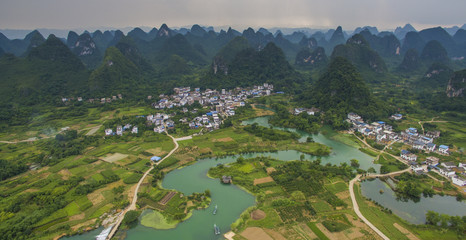 Aerial view of a village surrounded by karst and padi fields in Yongshua County China
