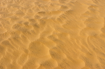 Fototapeta na wymiar Waves of sand in hot desert - aerial view