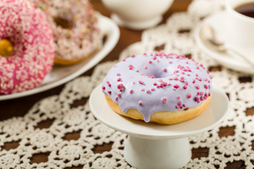 Colorful donuts on a wooden background.