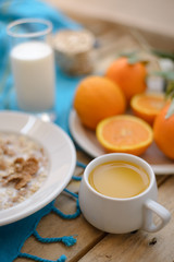 Healthy breakfast, fruit, corn flakes, milk and orange juice on the wooden table