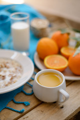 Healthy breakfast, fruit, corn flakes, milk and orange juice on the wooden table