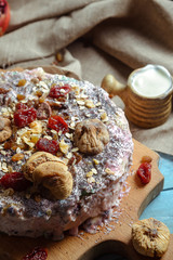 Homemade vegetarian pie with dried fruits on a blue background