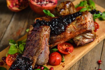 cold boiled pork with tomatoes on the wooden table