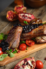 cold boiled pork with tomatoes on the wooden table