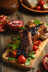 cold boiled pork with tomatoes on the wooden table