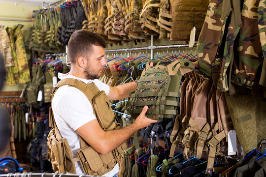 Male customer choose bulletproof vest