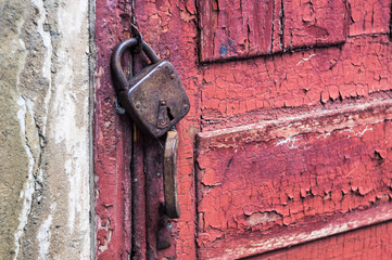 Old rusty padlock on the door.