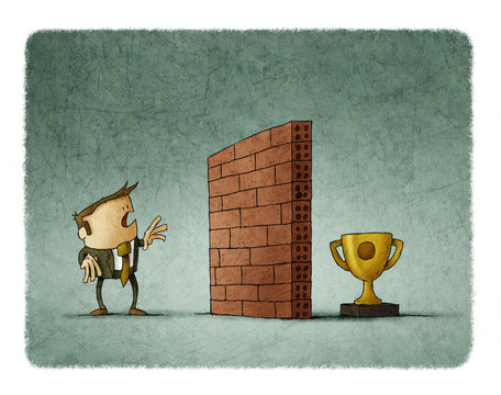 Business man in front of a brick wall has difficulty reaching his goal