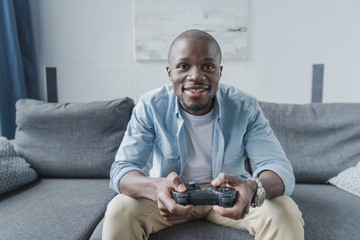 African american man playing with joystick