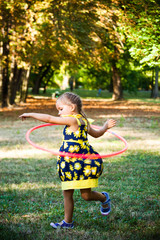 little girl play with hula hoop in park © Coka