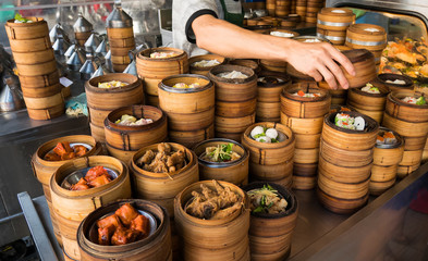 Hand of chef picked up a dim sum are steaming on the stove  Chinese restaurant that is popular in...