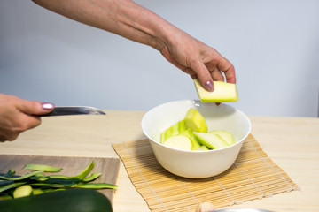 Obraz na płótnie Canvas Cutting of Zucchini for cooking