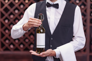 sommelier with bottle of wine