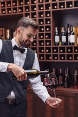 sommelier pouring red wine