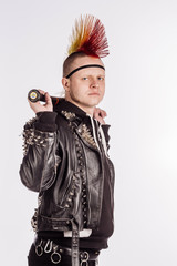 Portrait of punk rocker with Mohawk hairstyle holding baseball bat on a white background.