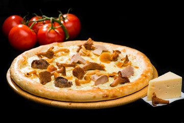 selective focus on classic appetizing Italian fresh cheese pizza with different types of mushrooms on wooden round board on dark background, near tomatoes and cheese