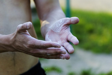 The young man sprinkle his hands with powder
