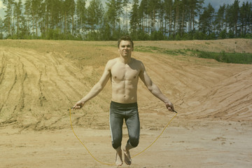 Fototapeta na wymiar Young man skipping rope