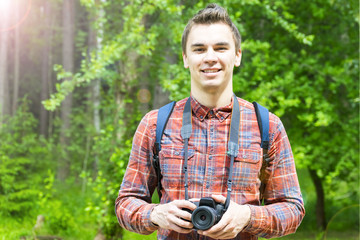 A young man takes photos of nature. Summer-Autumn.