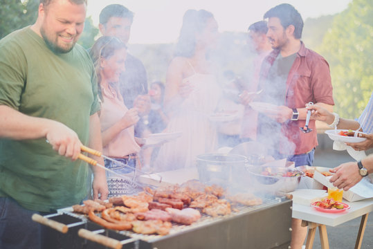 Group of people having barbecue at outdoor party