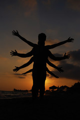 Silhouette of one body with lot of hands. Happy family play on summer vacation
